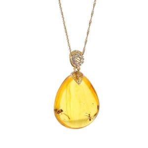 Unikatowa złota zawieszka bursztynowa w kształcie sopla z inkluzją, zdobiona cyrkoniami