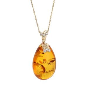 Unikatowa złota zawieszka bursztynowa w kształcie sopla z cyrkoniami